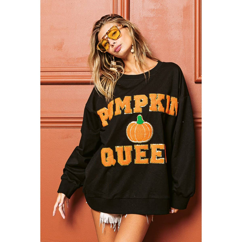 Black sweatshirt with orange “PUMPKIN QUEEN” text and pumpkin patch graphic, crewneck
