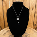 Silver-tone crystal key necklace with circular crystal bezel and key charm
