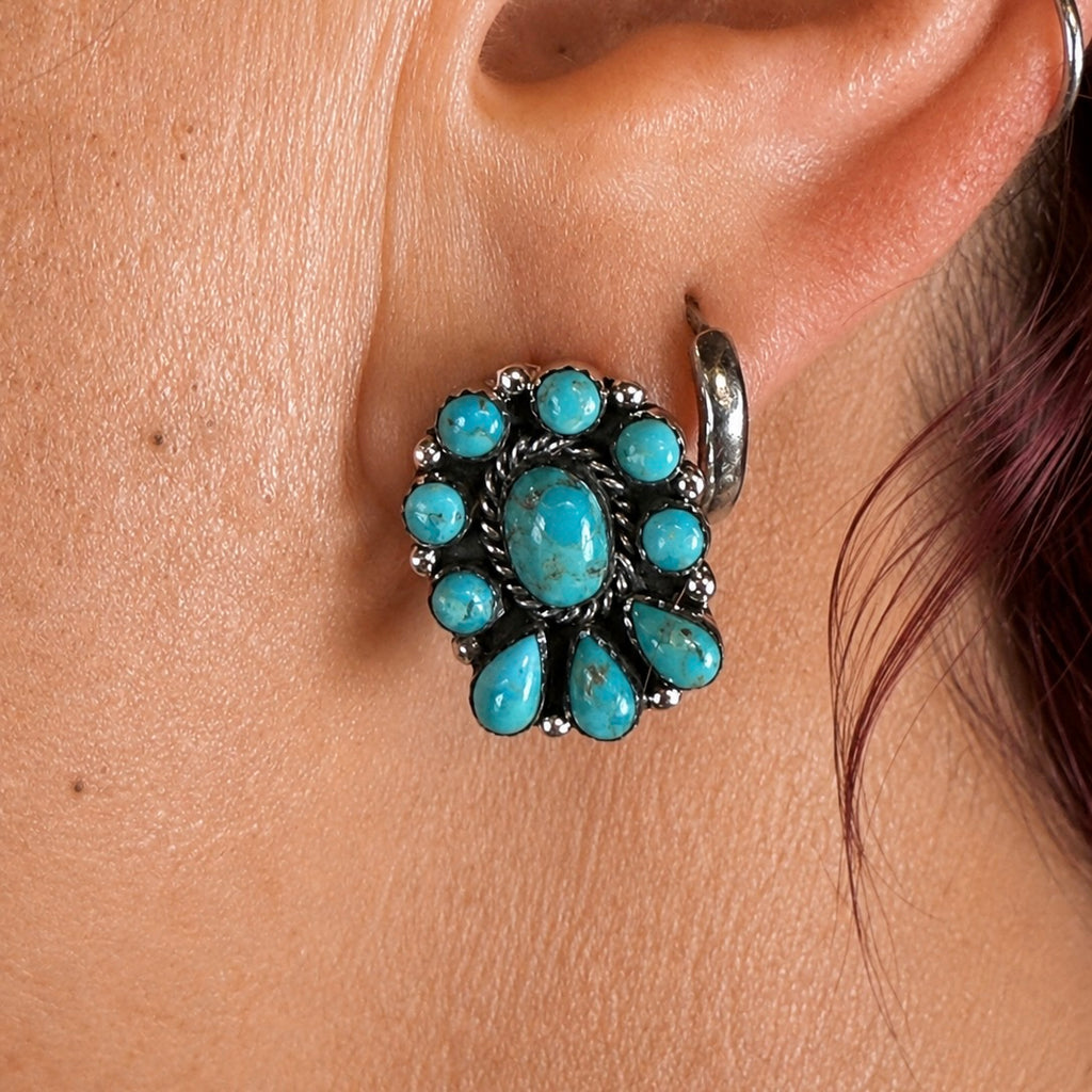 Turquoise oval centerpiece flower earring with surrounding round and teardrop stones