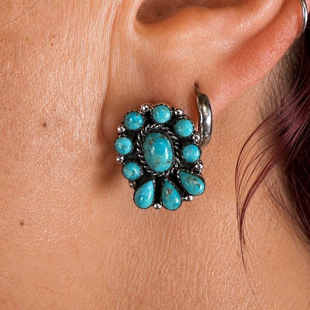 Turquoise oval centerpiece flower earring with surrounding round and teardrop stones