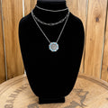 Layered western necklace on bust: silver chain choker and turquoise flower pendant