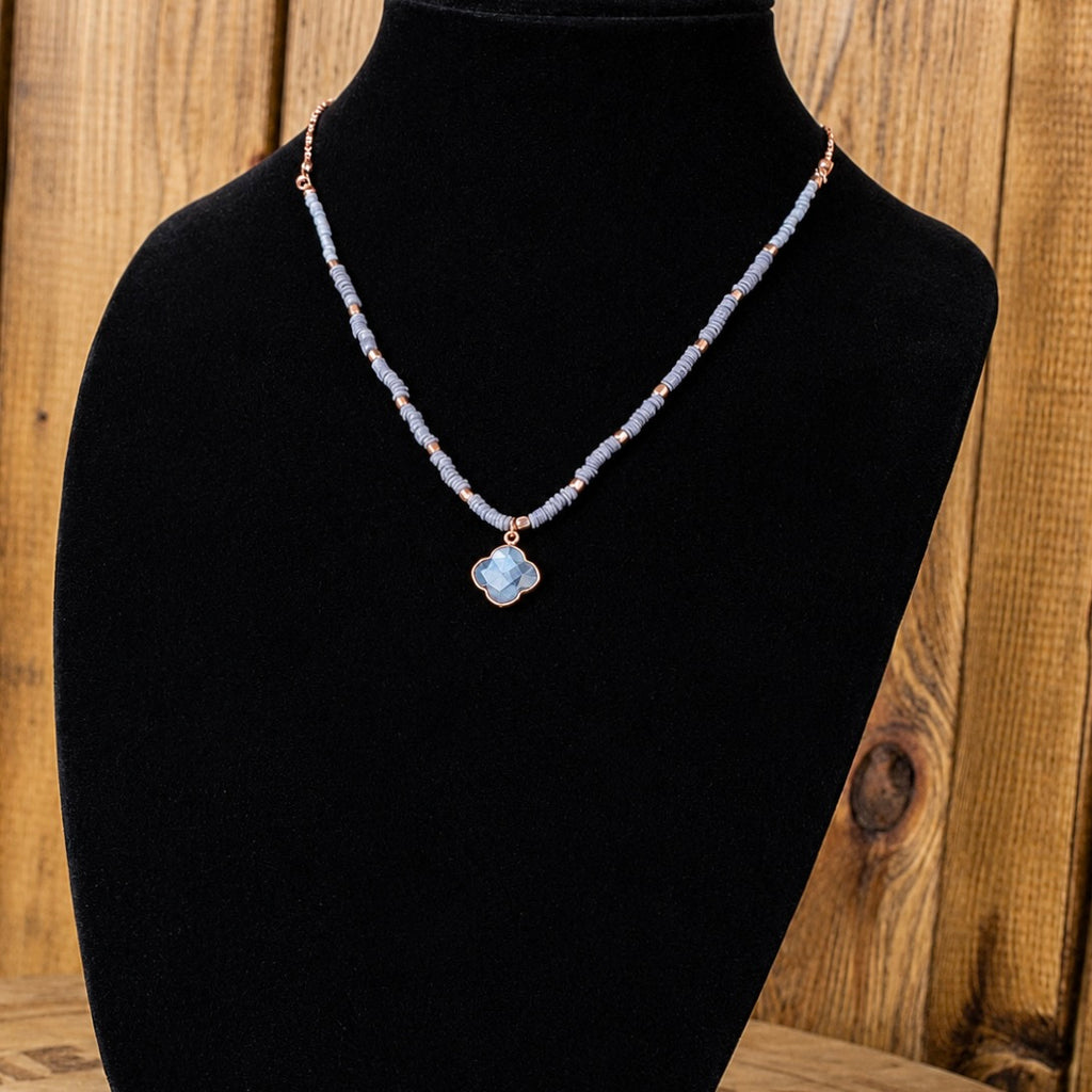Beaded quartz necklace with small light-blue beads and flower-shaped pendant