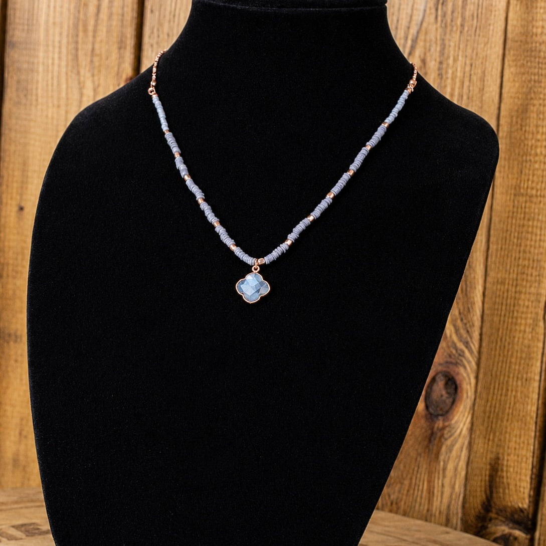 Beaded quartz necklace with small light-blue beads and flower-shaped pendant