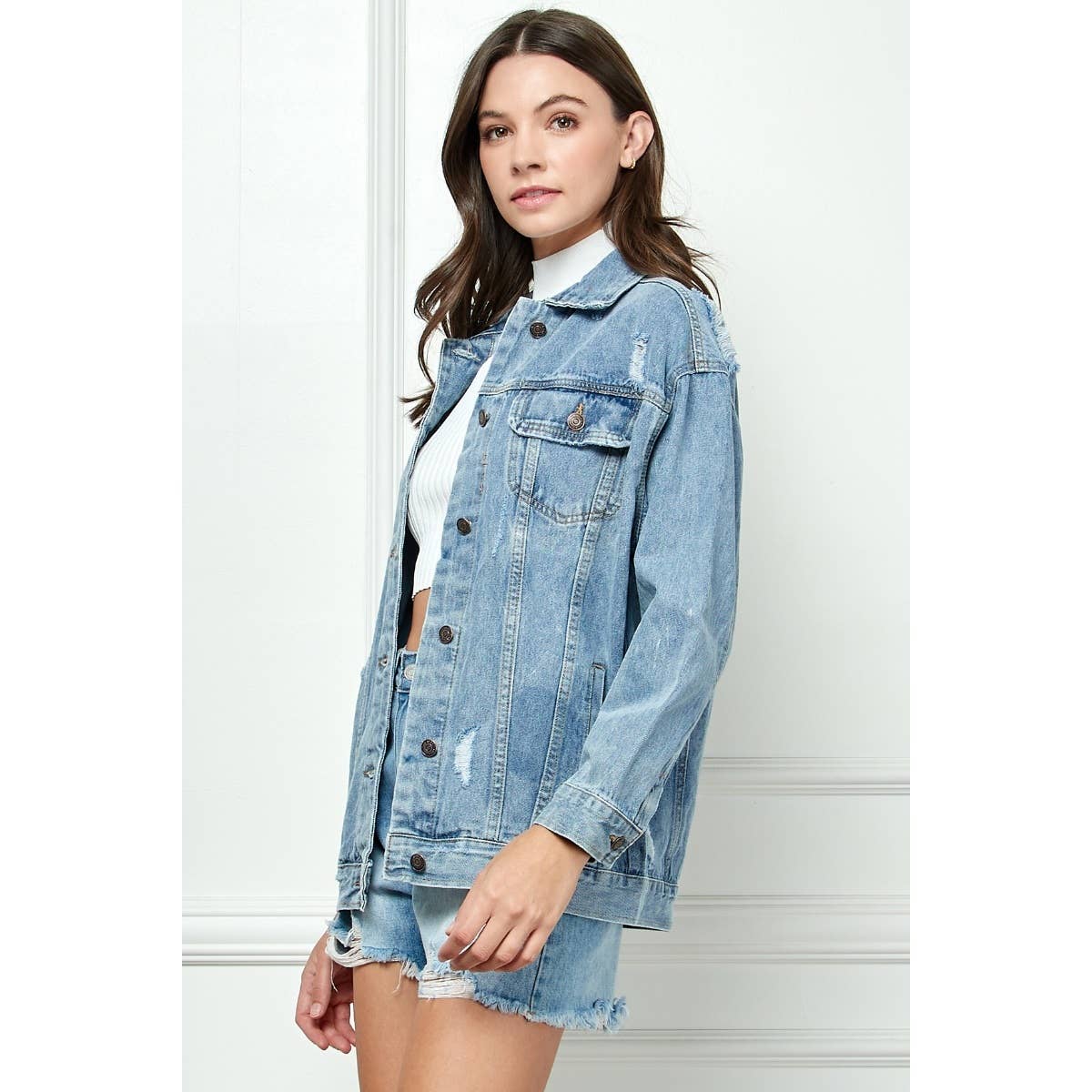 Medium-wash distressed denim jacket with button front and flap chest pockets