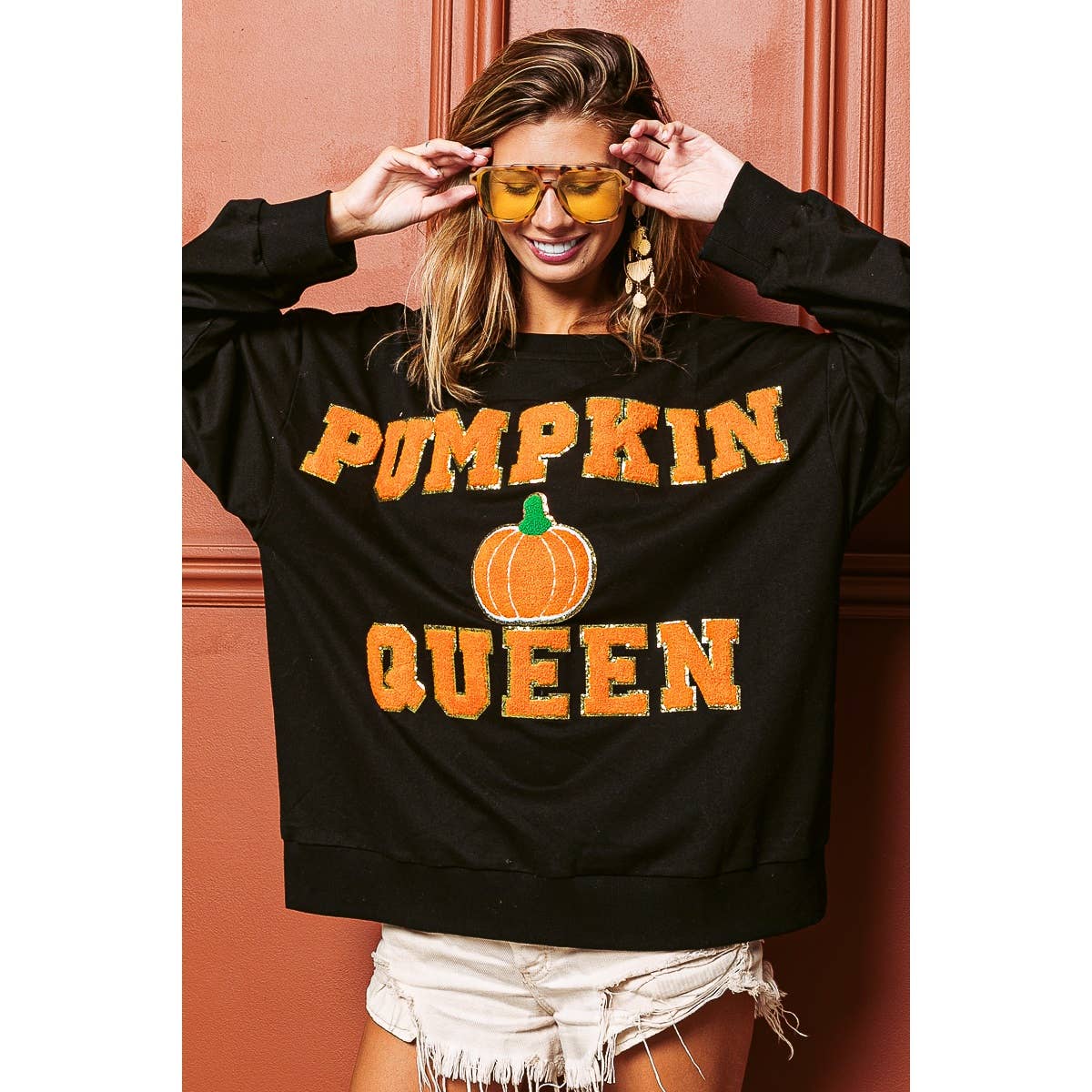 Black sweatshirt with bold “PUMPKIN QUEEN” lettering and pumpkin graphic, relaxed fit