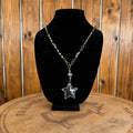 Star pendant necklace with gold-tone chain and dangling beads, medium blue stone center