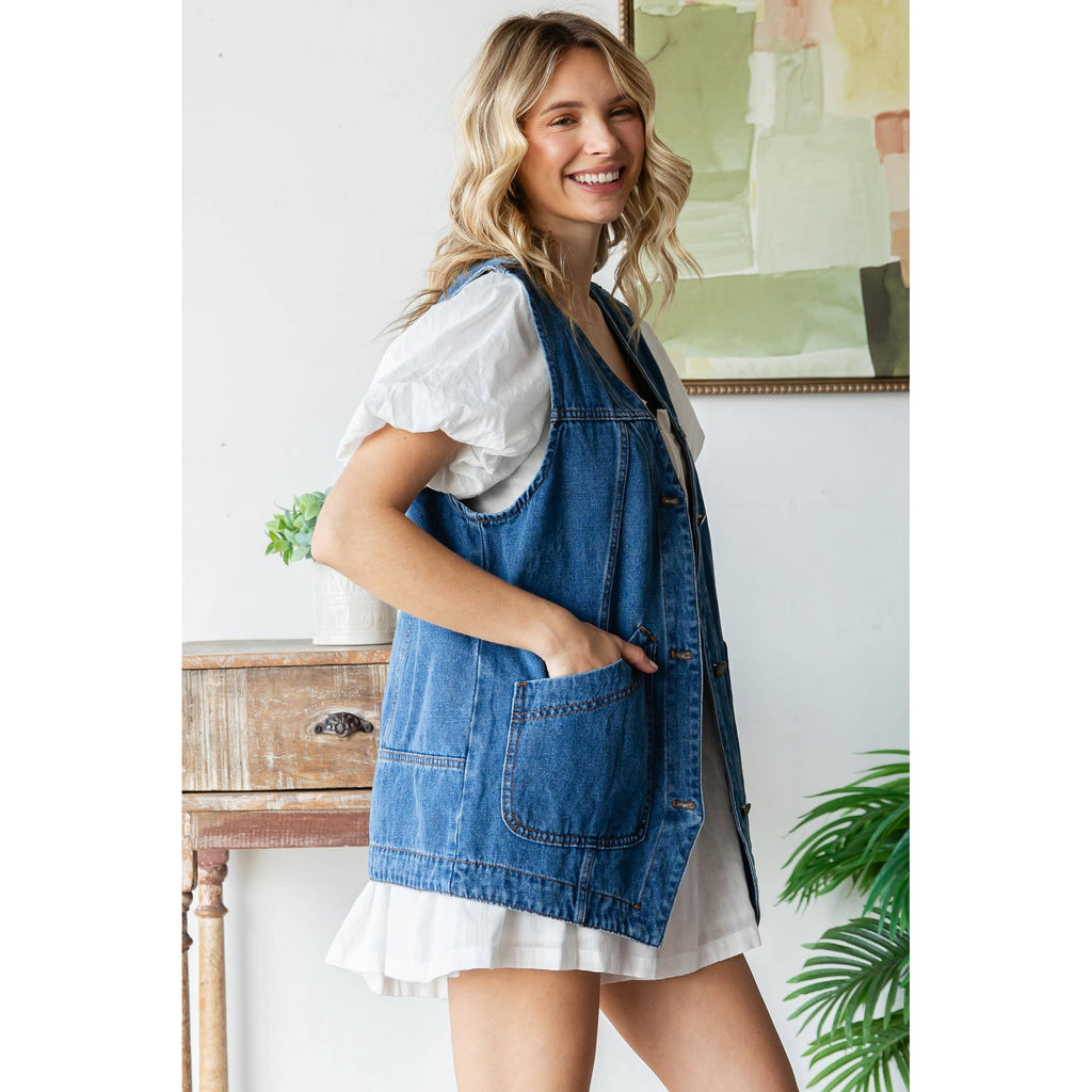 Blue denim vest with angled front pockets and sleeveless open-front design