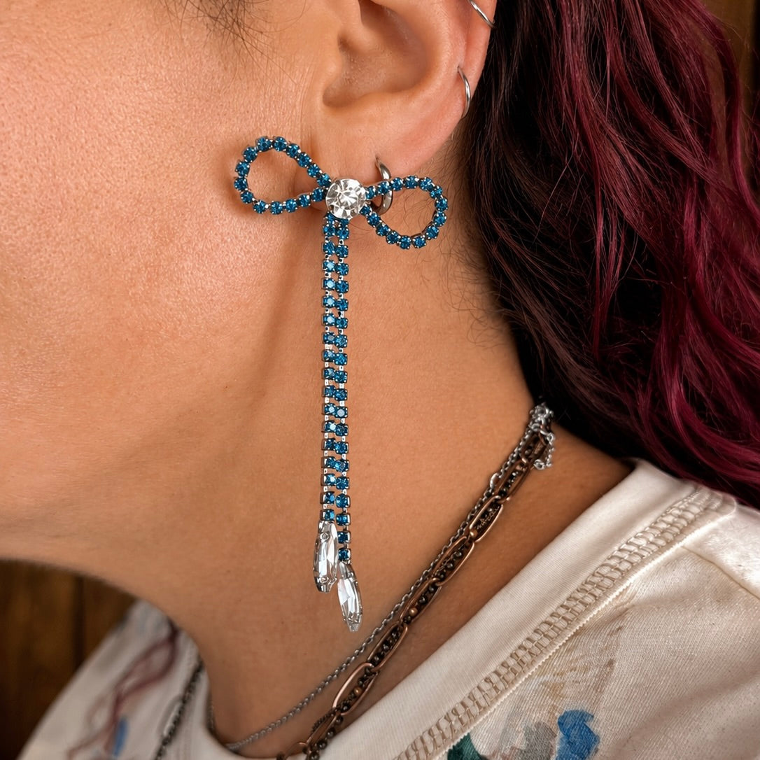 Blue rhinestone lariat earrings with bow-like loops and crystal drop tassel