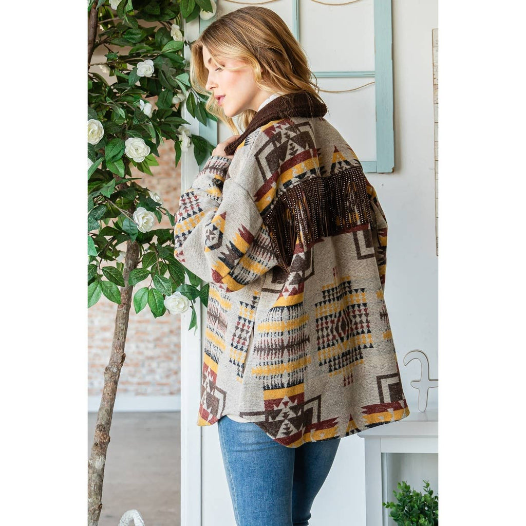 Taupe patterned thick knit shacket side view with dark fringe and button placket