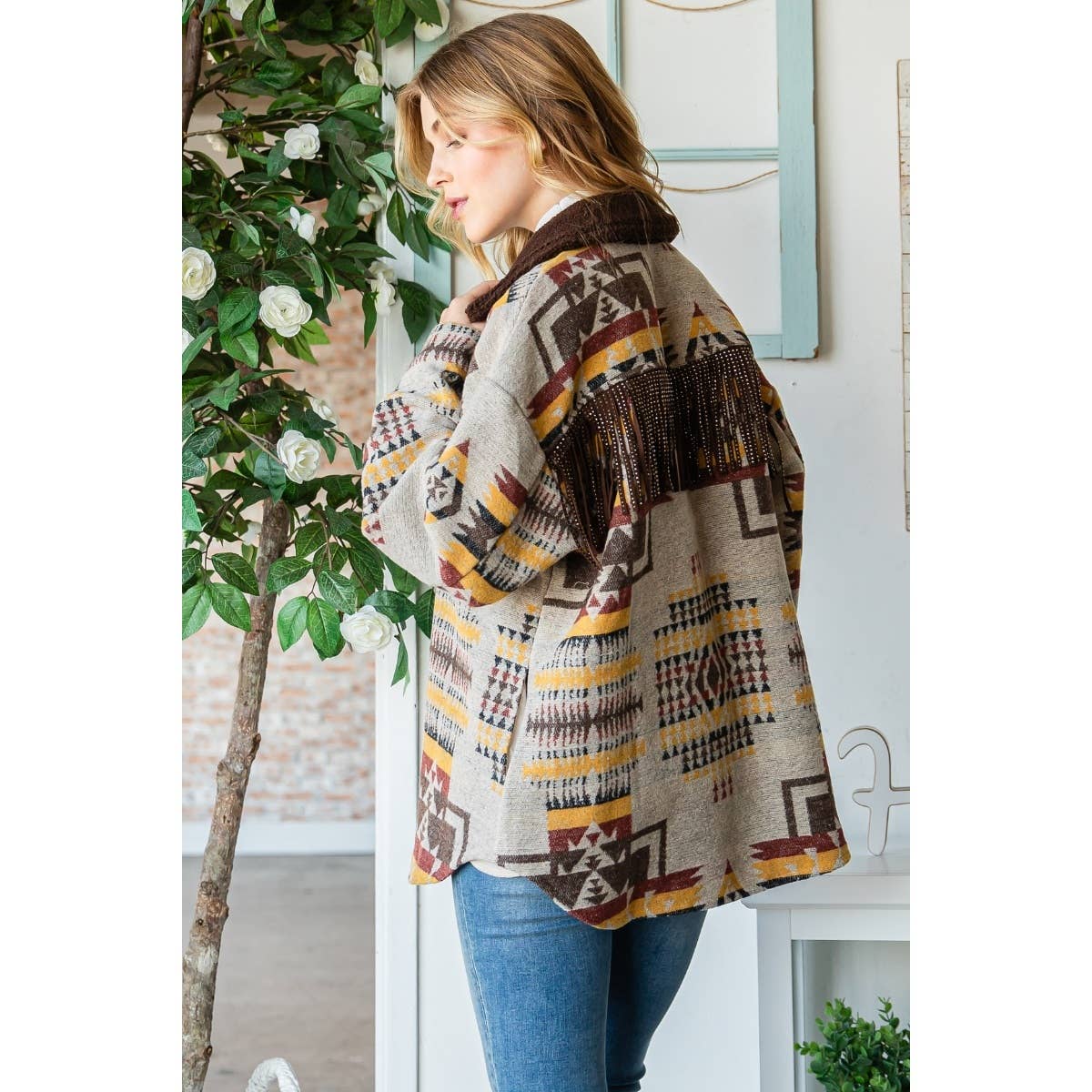 Taupe patterned thick knit shacket side view with dark fringe and button placket