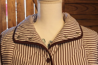 Brown striped quilted puffer vest front with stand collar and button placket