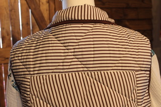 Brown striped quilted puffer vest back view with stand collar and stitching