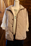 Brown striped quilted puffer vest on mannequin with stand collar and button placket