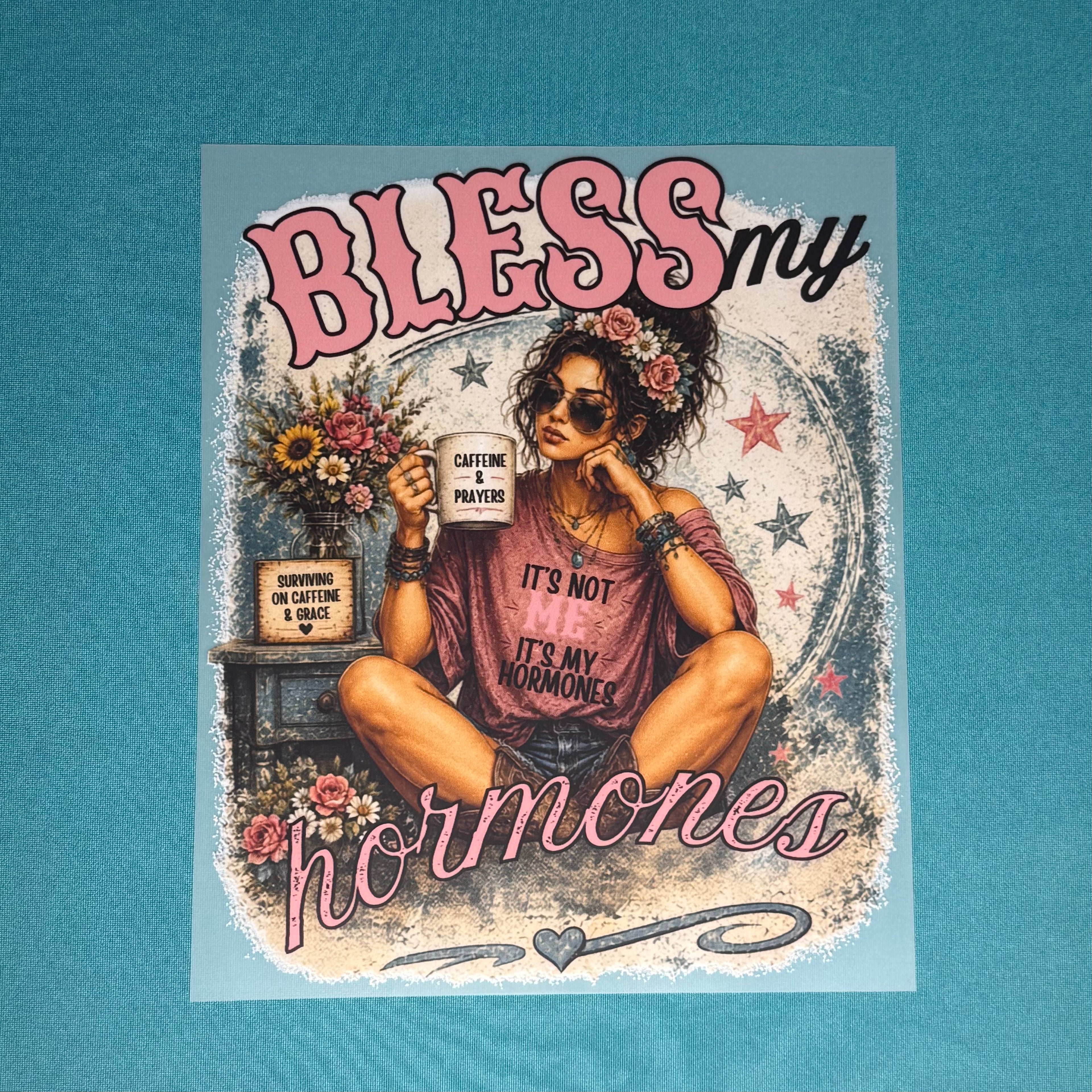 Maroon graphic T-shirt with "Blies my hormones" text and floral woman illustration