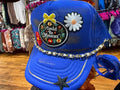 Blue baseball cap with embroidered patches and beaded chain trim; front star detail