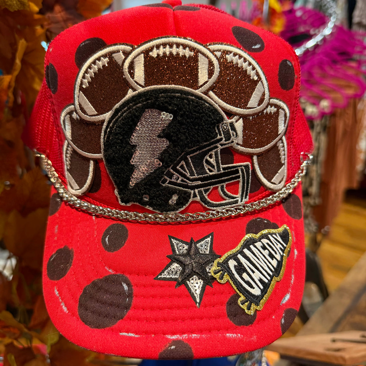Red baseball cap with football and star patches and stitched logo