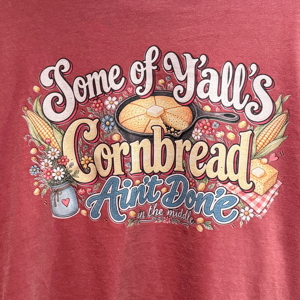 Front graphic T-shirt close-up: bold lettering with skillet and floral accents