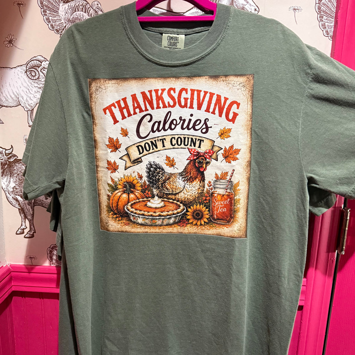 Green T-shirt with Thanksgiving “Calories” graphic: turkey, pie, pumpkin, and jar