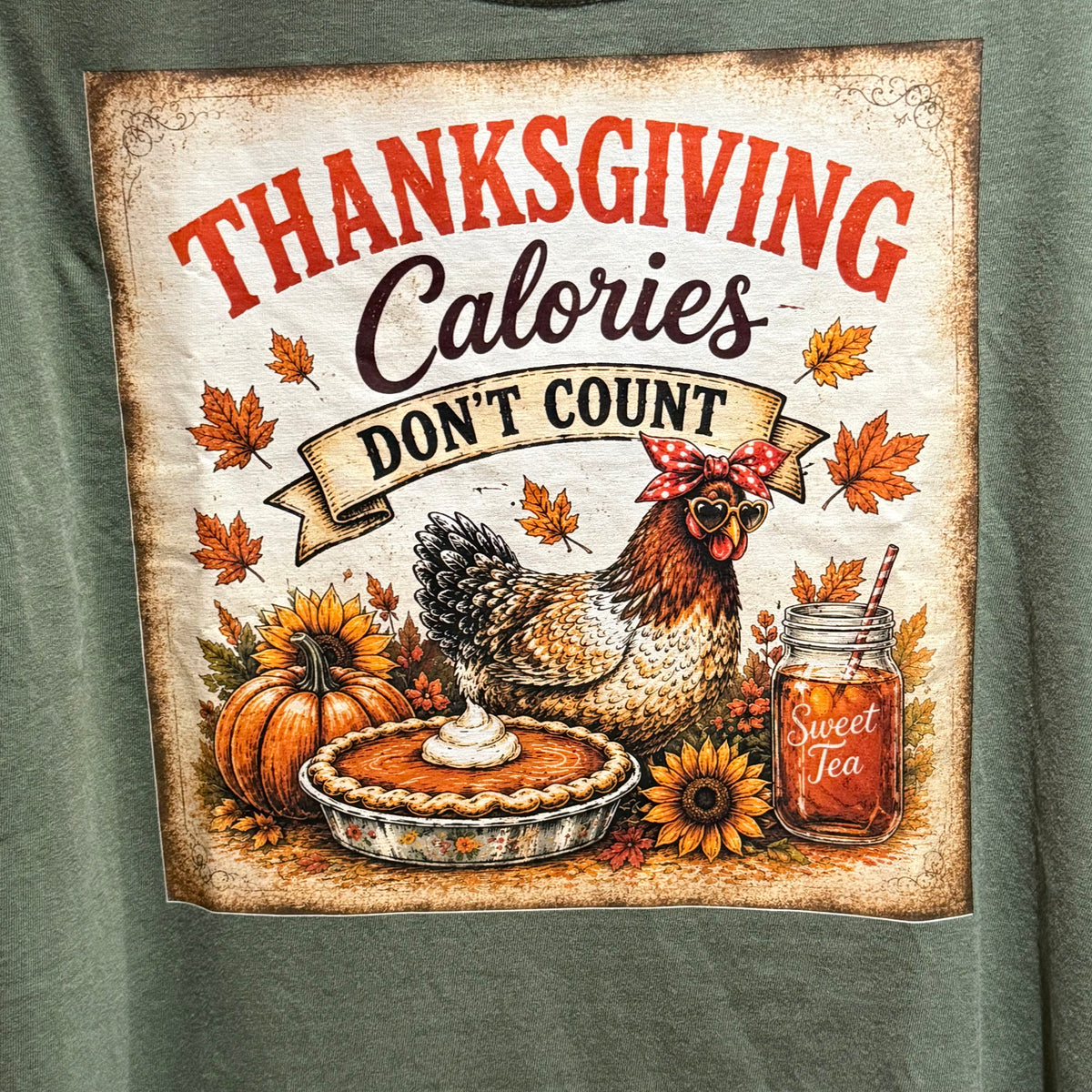 Green T-shirt graphic close-up: turkey and pie with Thanksgiving “Calories” text