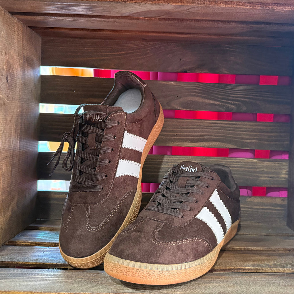 Brown suede low-top sneakers with white stripes, lace-up front and gum sole