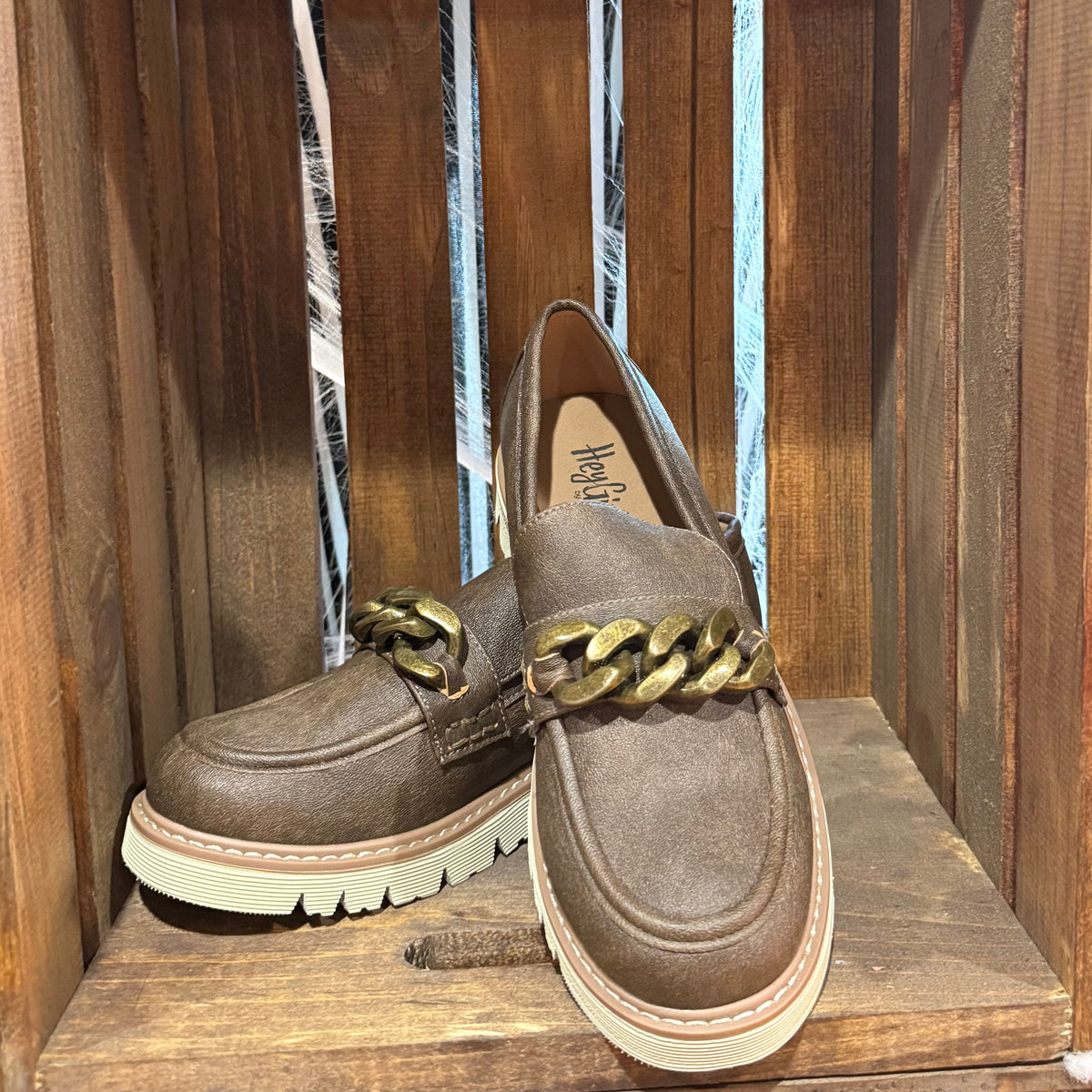 Chocolate-brown suede loafers with gold chain strap, slip-on style, white sole