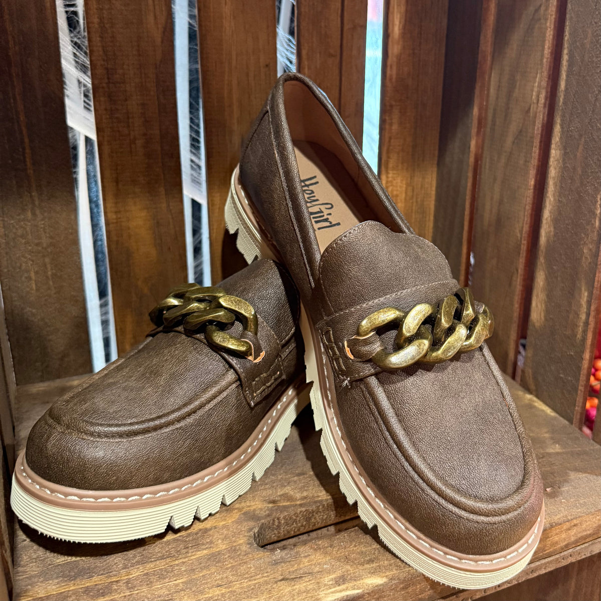 Chocolate-brown suede loafers with gold chain detail and white tread sole