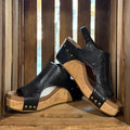 Black heeled sandal with open toe, stud trim, cork-textured wedge sole.