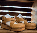 Tan leather wedge sandals with open toe straps and cork-style platform heel