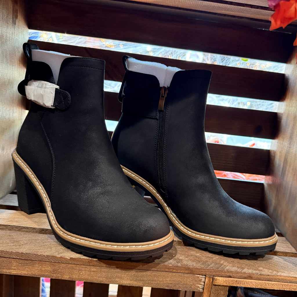 Black ankle boots with side zips, chunky block heels, and tan contrast sole trim