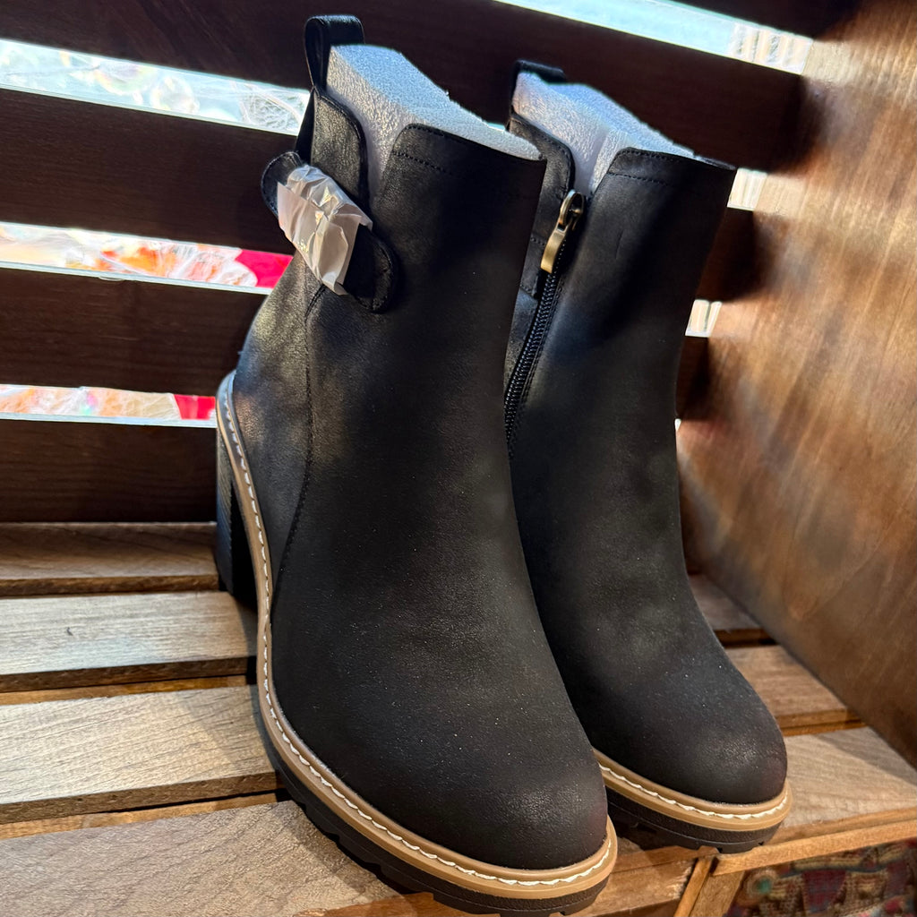 Black ankle boots angled view with side zipper, buckle strap detail, and tan sole trim