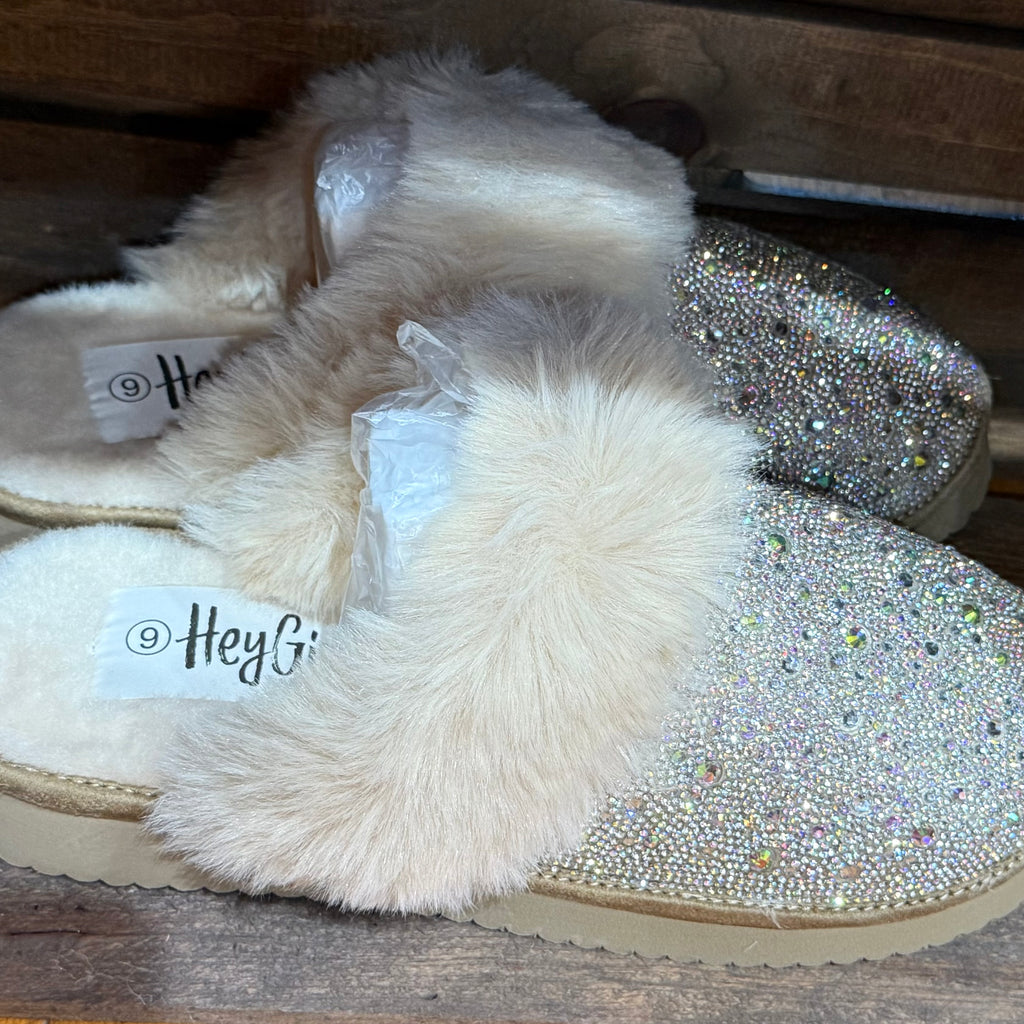 Pair of light glitter slip-on slippers with white faux-fur straps and stitched sole