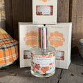 Clear glass eau de parfum bottle with illustrated autumn label and matching box