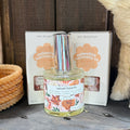 Glass eau de parfum bottle with silver cap and 'velvet hearth' label, with gift box