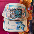 Cream trucker hat with front embroidered coffee graphic and blue starfish, curved brim