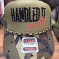 Olive trucker hat with black embroidered text and red script, mesh back, snap strap.