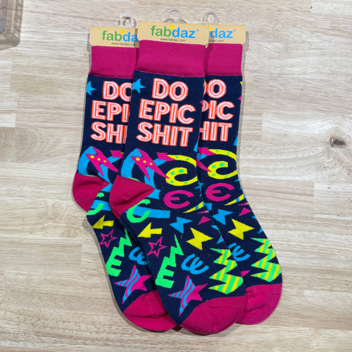 Magenta and multicolor crew socks with “DO EPIC SHIT” and star patterns