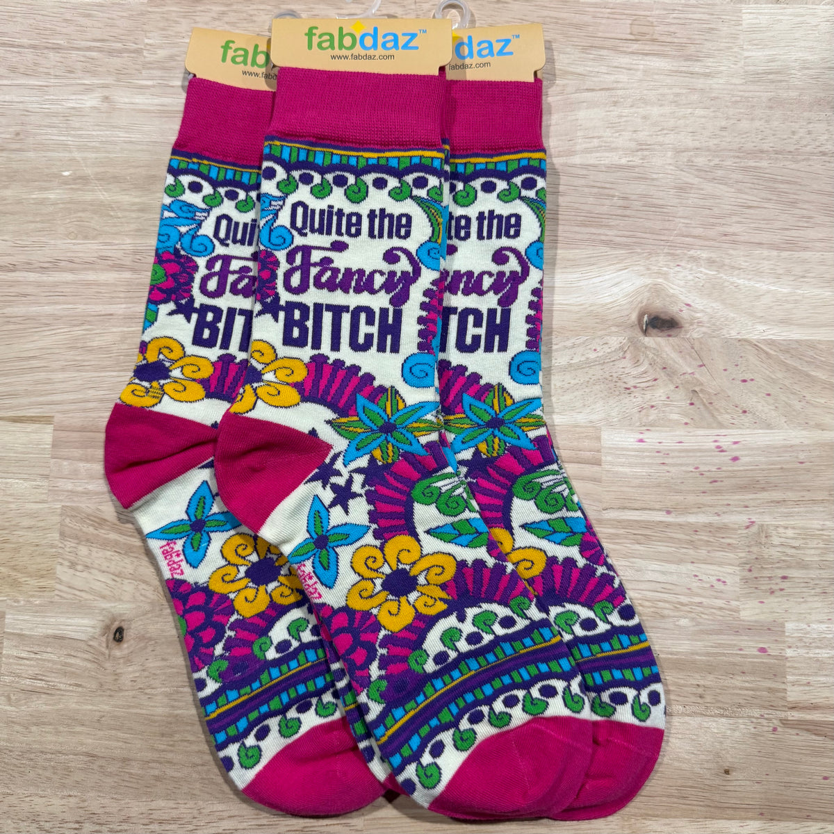 Fuchsia and multicolor crew socks with “QUITE THE FANCY” and butterfly pattern