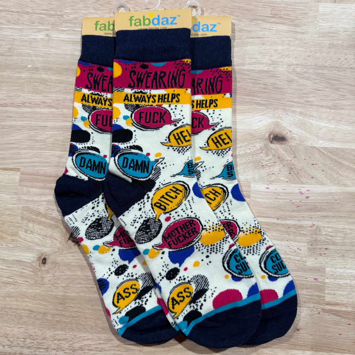 Navy and white crew socks with “SWearing,” “ALWAYS HELPS,” and “DAMN” text