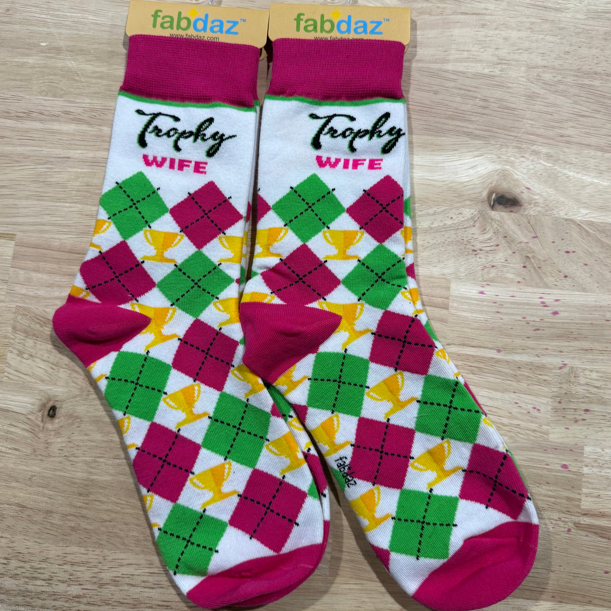 Funny socks with argyle pattern in pink, green, and purple and 'Trophy Wife' text.