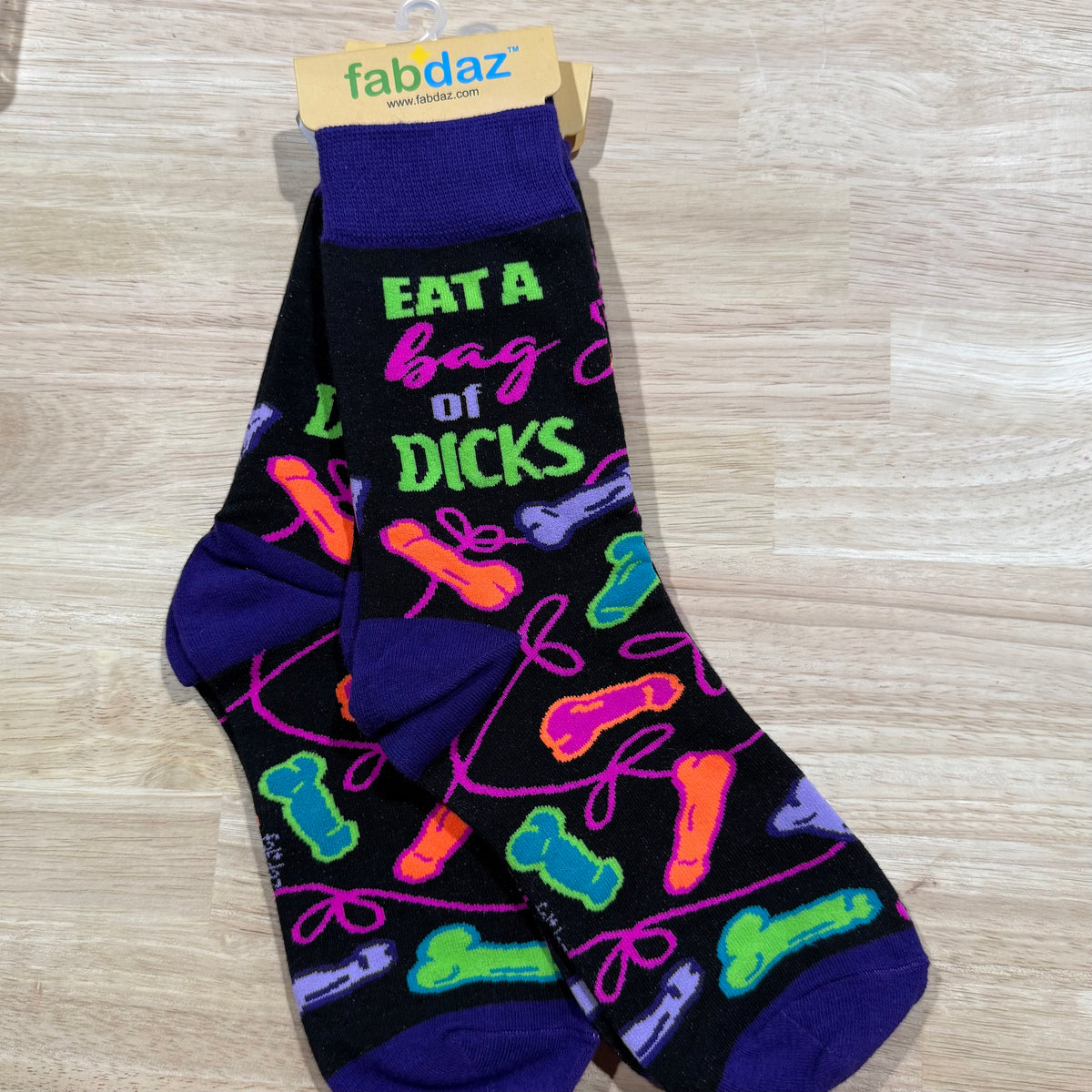Dark purple adult novelty socks with green “EAT A bag” lettering and colorful icon pattern