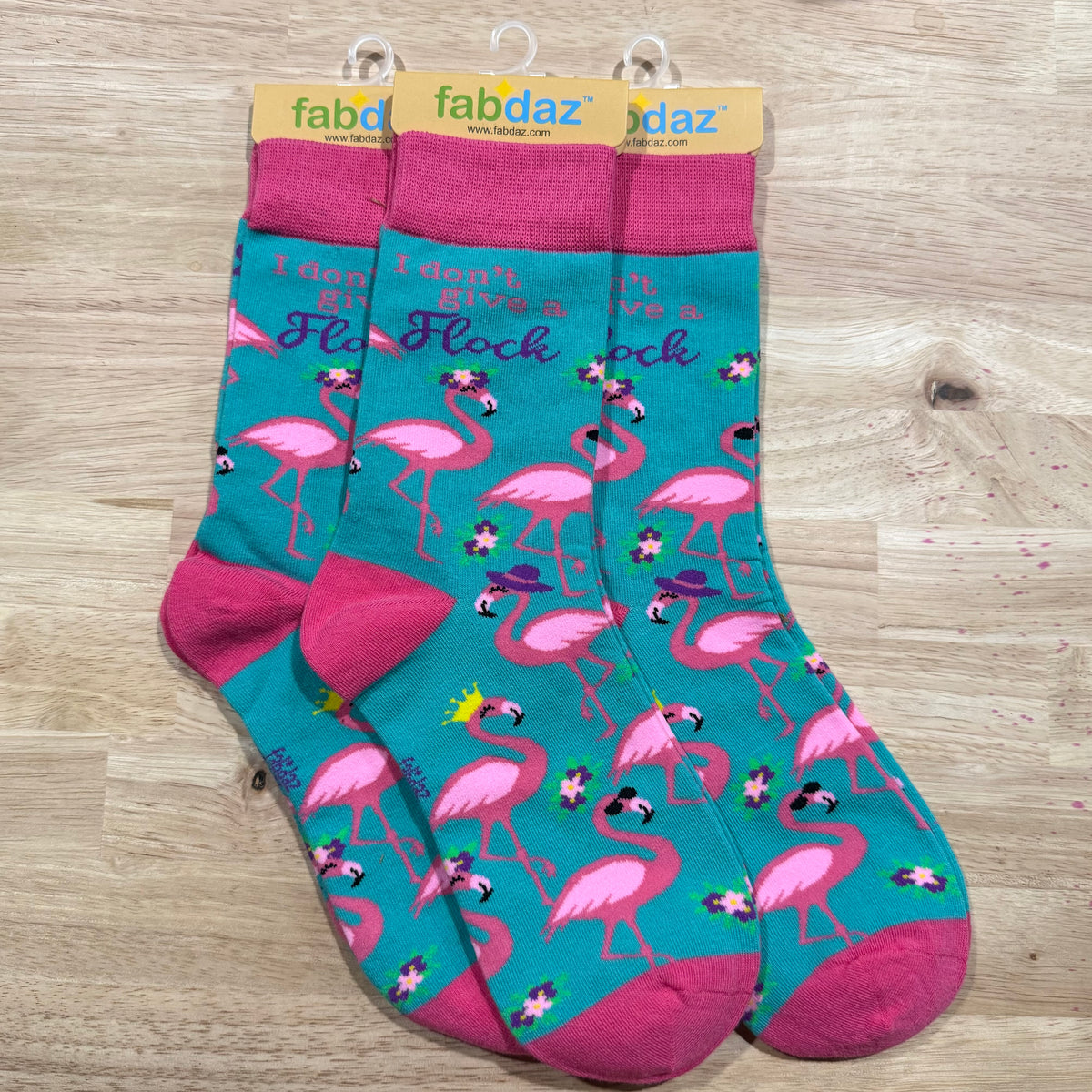 Pink and teal flamingo adult novelty socks with fun lettering across the top
