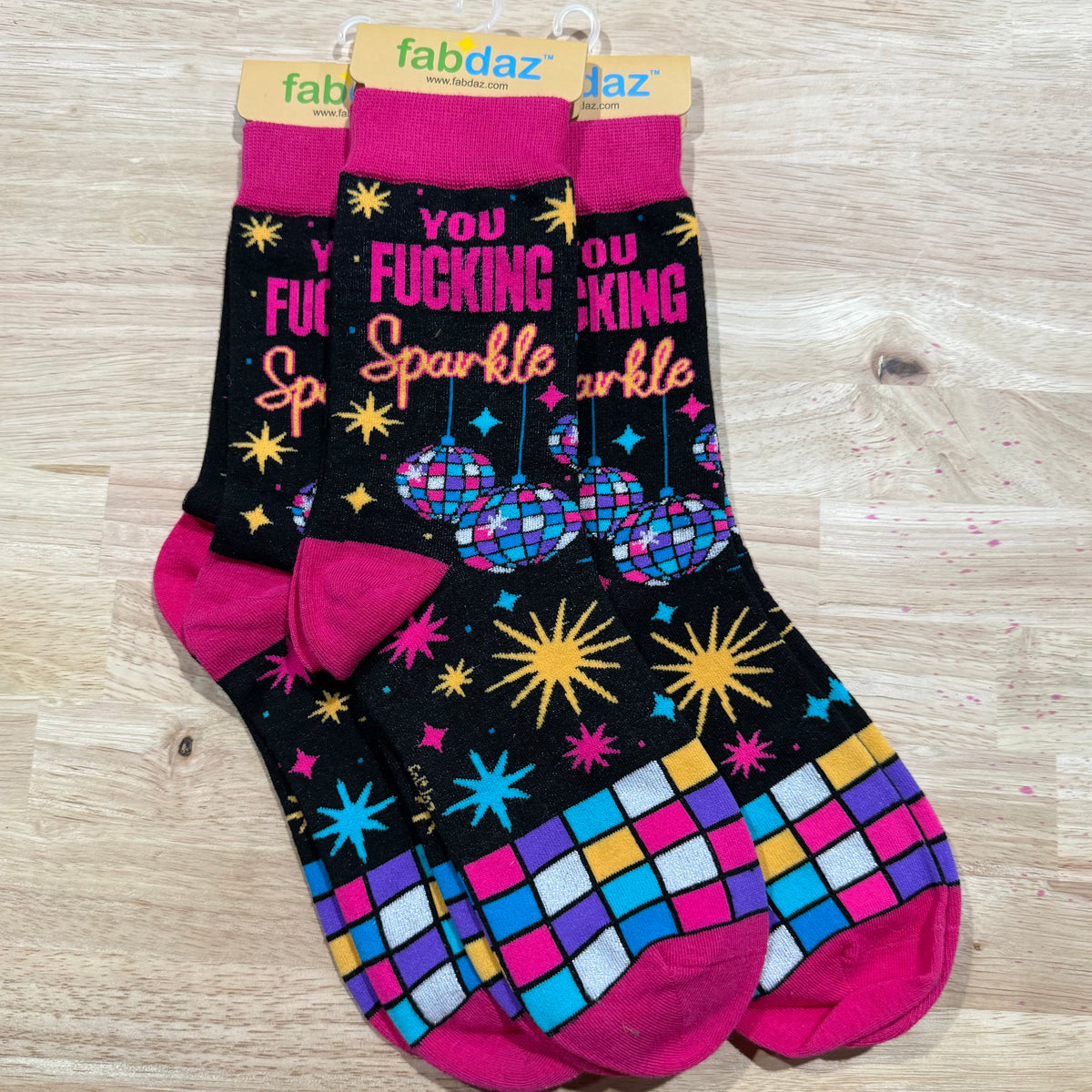 Black adult novelty socks with “You fucking sparkle” lettering and star, disco-ball graphics