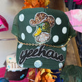 YeeHaw green trucker hat with sequin dog patch, polka-dot stitching, and gold chain trim