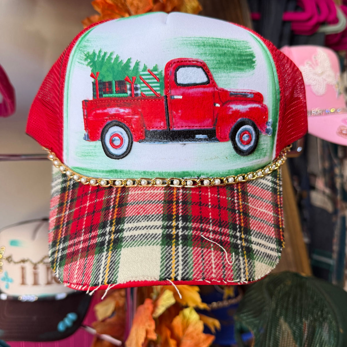 Christmas truck cap with embroidered red pickup on white front and plaid brim