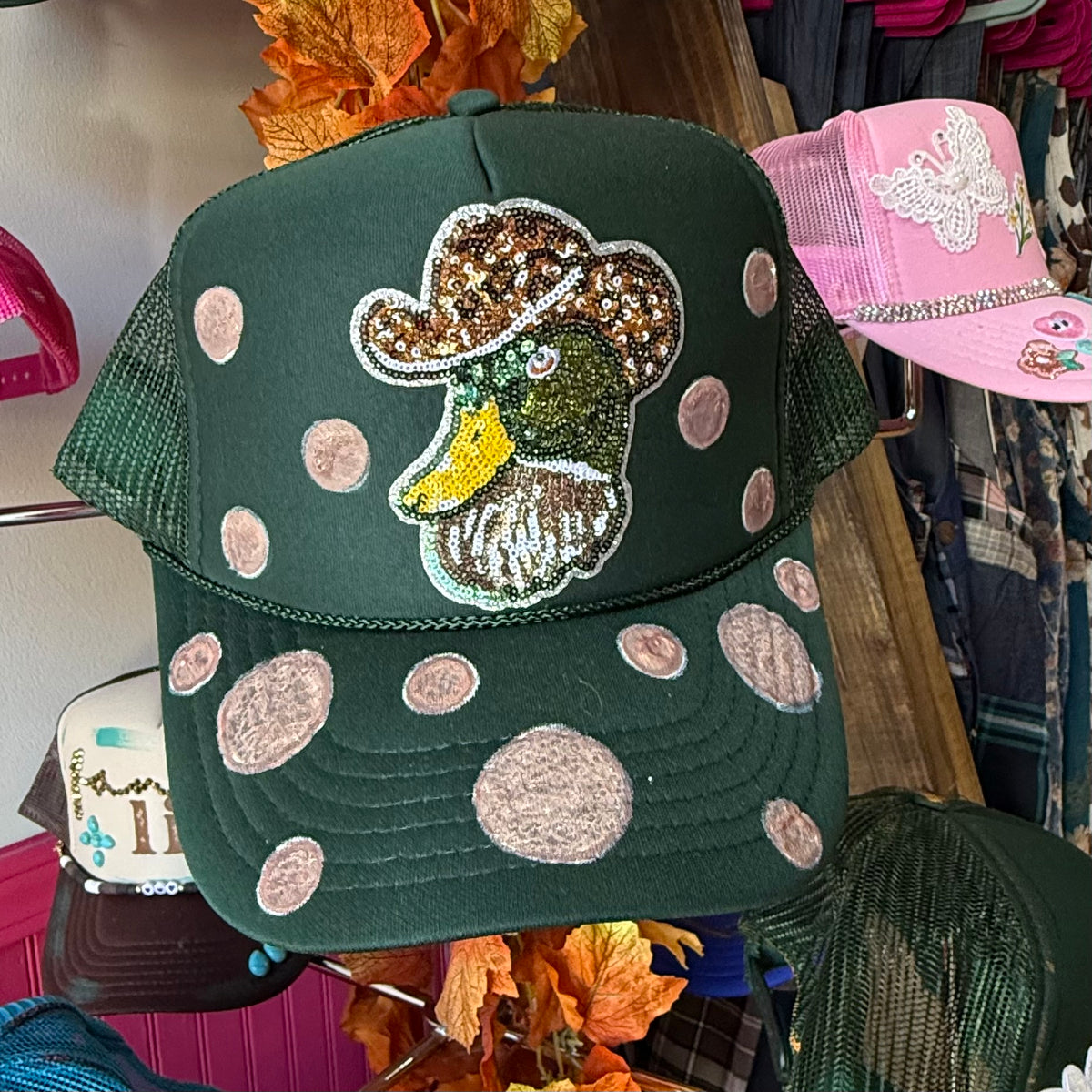 Green trucker hat with sequin cowboy duck patch and pink polka-dot accents