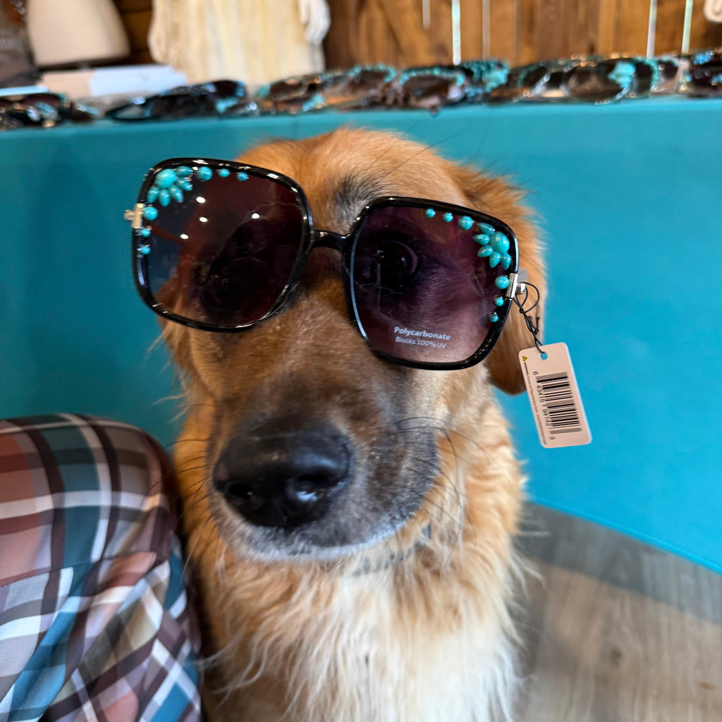 Turquoise sunglasses with black round lenses, teal beaded accents, and visible tag