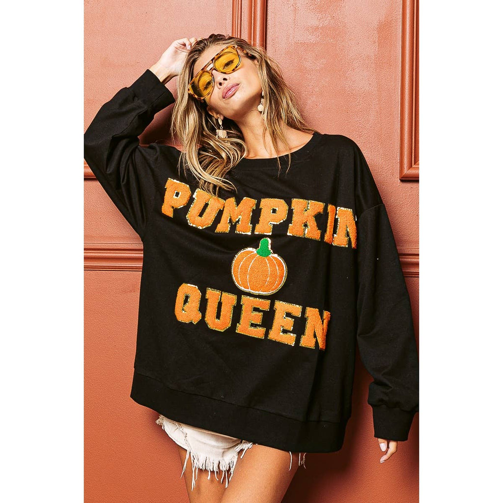 Black sweatshirt with orange "PUMPKIN QUEEN" text and central pumpkin graphic