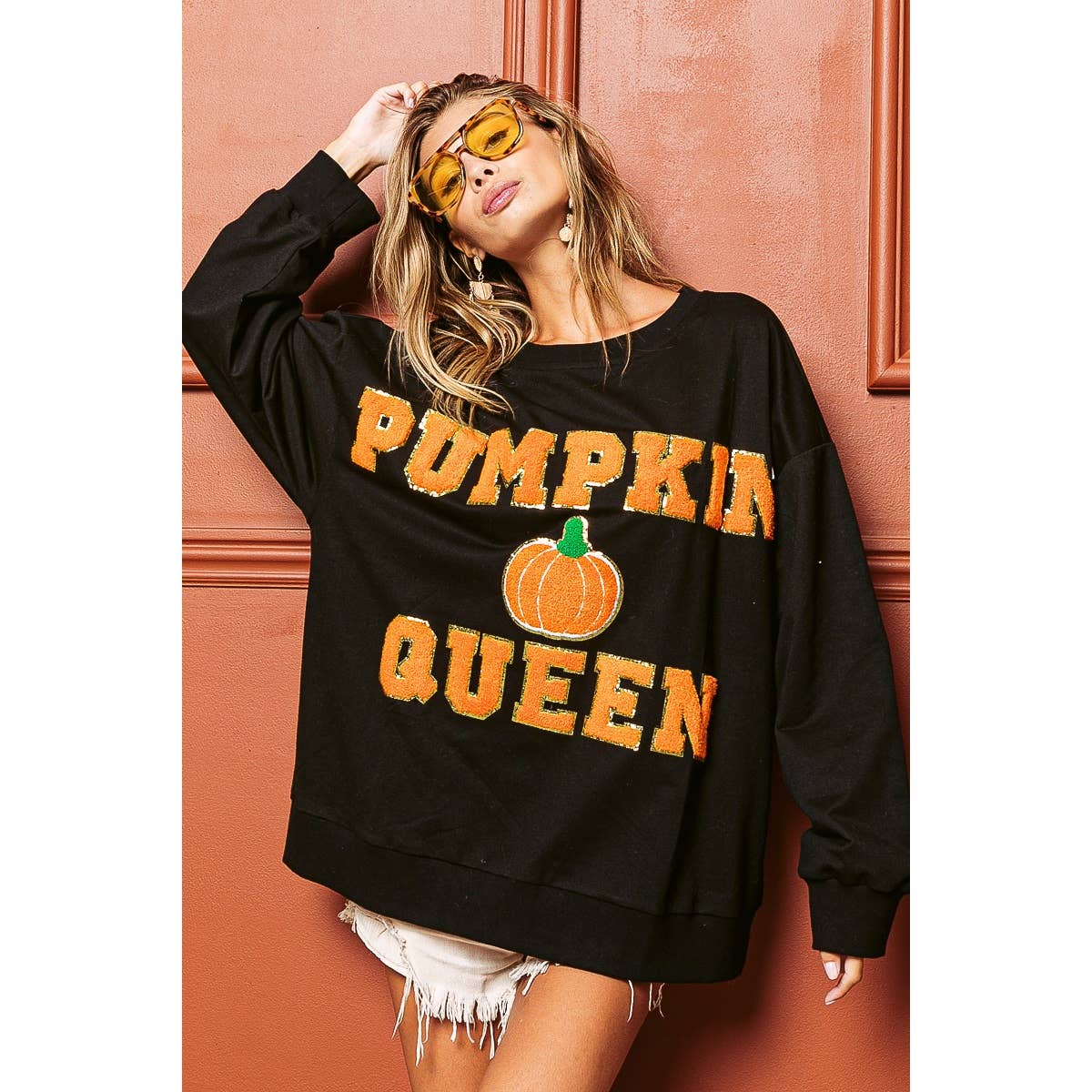 Black sweatshirt with orange "PUMPKIN QUEEN" text and central pumpkin graphic