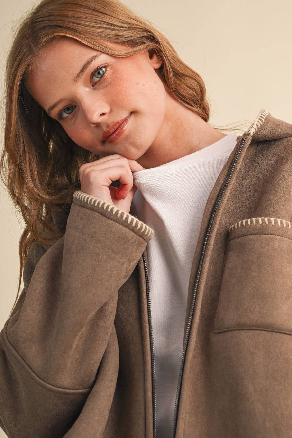 Taupe hooded jacket detail with contrasting blanket-stitch trim and sherpa lining