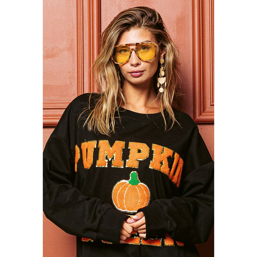 Black sweatshirt front with orange "PUMPKIN QUEEN" text and pumpkin applique